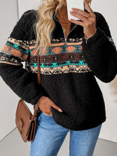 Stylish quarter zip sweatshirt with geometric patterns in black, featuring cozy fabric and side pockets.