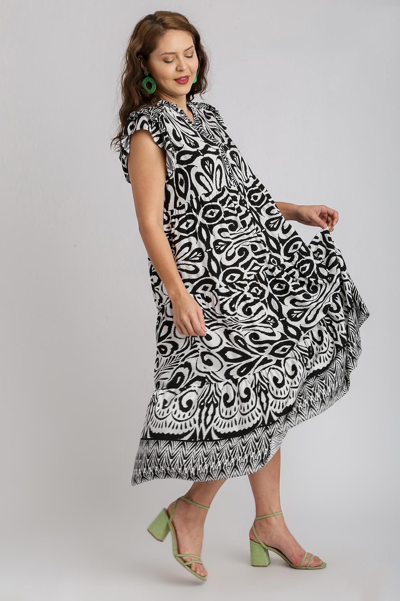 Plus size woman wearing Umgee two-tone border print ruffle cap sleeve midi dress, showcasing elegant flow and style.