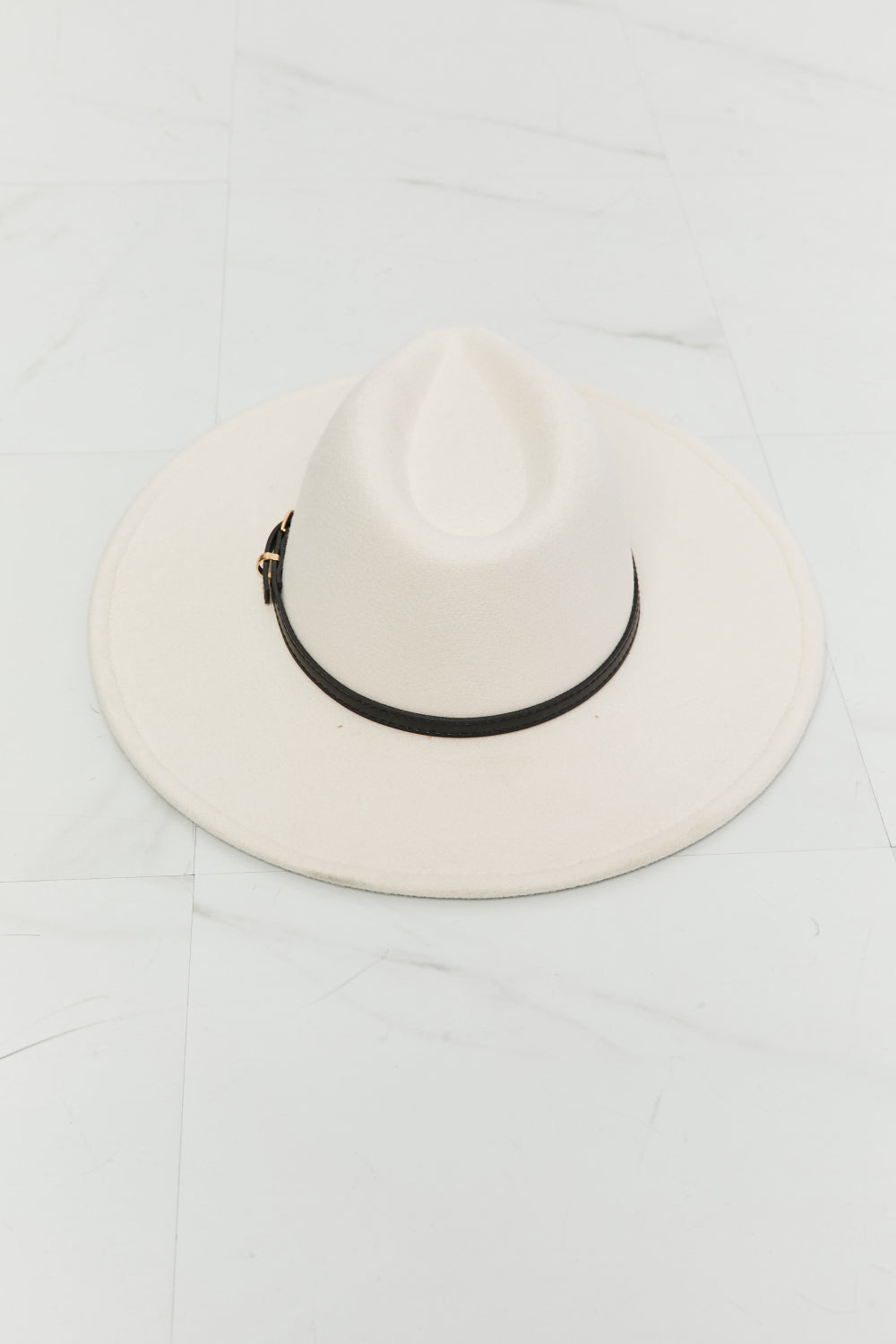 Beige fedora hat with a black belt and gold hardware, perfect for adding sophistication to any outfit.