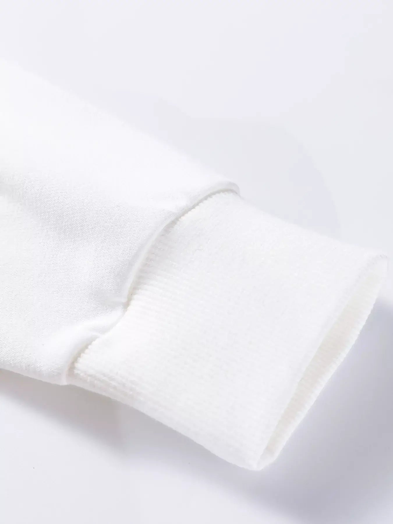 Close-up of the sleeve cuff of the Plaid MERRY Christmas Vacation Sweatshirt, showcasing its soft fabric.