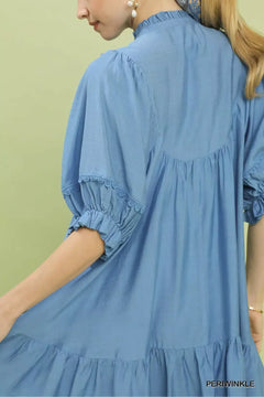 Umgee Smocked Bib Ruffle Hem Babydoll Dress in periwinkle with puff sleeves and ruffle hem detail.
