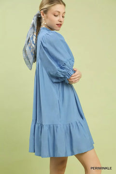 Umgee Smocked Bib Ruffle Hem Babydoll Dress featuring a ruffled hem and puff sleeves in a beautiful blue color.