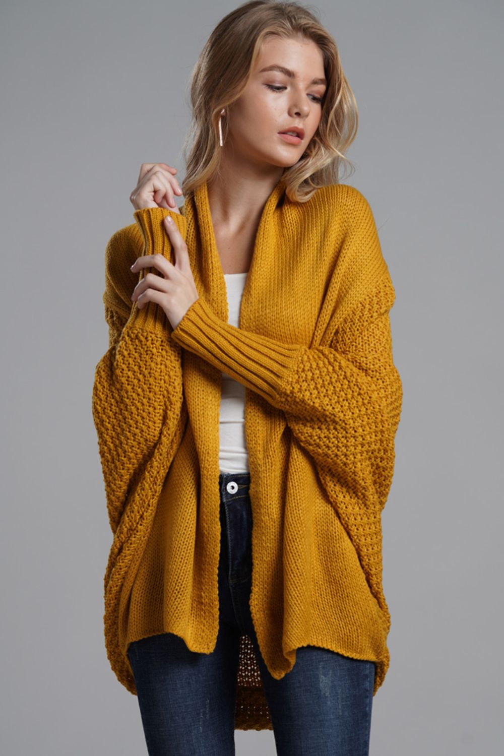 Model wearing a mustard yellow Double Take Dolman Sleeve Longline Cardigan with ribbed trim, styled casually.