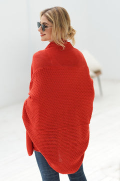 Model wearing a red double take dolman sleeve open front cardigan, showcasing its stylish and cozy design.