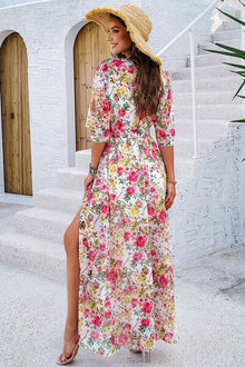 Elegant floral printed tied half sleeve slit dress, perfect for summer outings, displayed outdoors with a stylish hat.