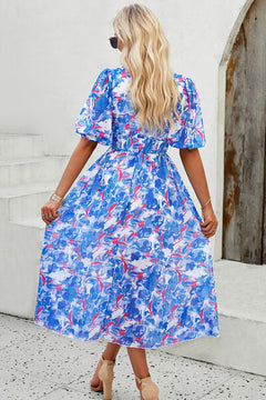 Back view of a blue floral smocked V-neck short sleeve dress, perfect for summer outings.