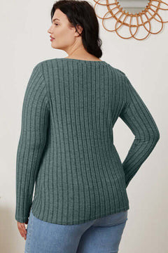 Rear view of a model wearing a ribbed green long sleeve T-shirt with a relaxed fit.