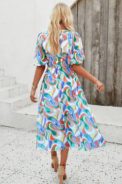 Smocked printed v-neck short sleeve dress with colorful swirl pattern, perfect for a casual summer look.