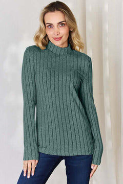 Model wearing a Basic Bae ribbed mock neck long sleeve t-shirt in green, showcasing its fitted style and ribbed texture.