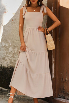 Tie shoulder smocked tiered dress in soft beige, perfect for summer with a stylish, flowing fit.