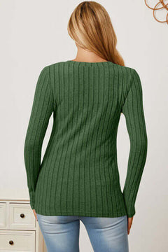 Back view of a woman wearing a green ribbed long sleeve t-shirt, showcasing a stylish and comfortable design.