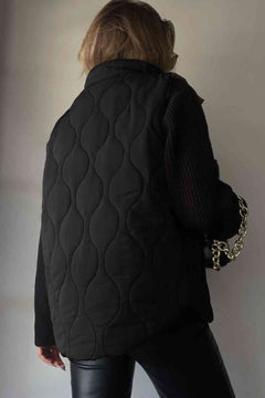 Back view of a collared black quilted vest, showcasing a stylish design and textures.