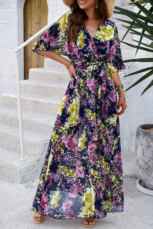 Elegant printed tied half sleeve slit dress featuring vibrant floral patterns, perfect for summer outings.