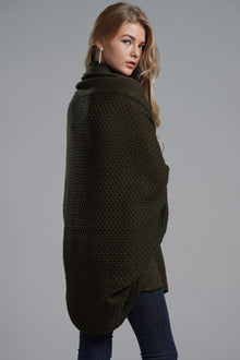 Model wearing a longline cardigan with dolman sleeves in olive green, showcasing ribbed details and open front style.
