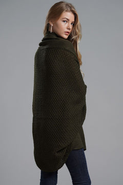 Model wearing a longline cardigan with dolman sleeves in olive green, showcasing ribbed details and open front style.