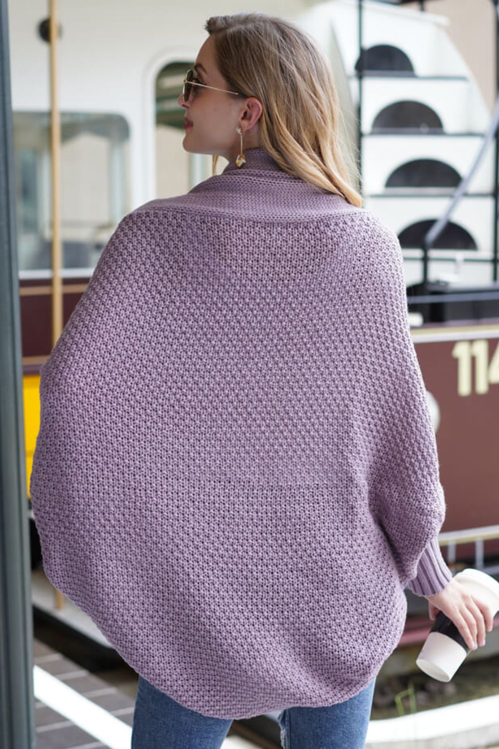 Model showcasing a lavender dolman sleeve open front cardigan with ribbed details, exuding casual chic style.