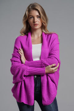 Stylish model wearing a vibrant pink dolman sleeve open front cardigan with ribbed details.