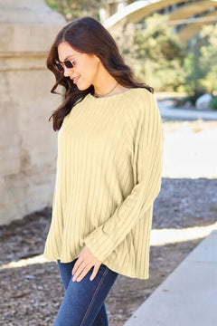 Women in a light yellow ribbed long sleeve knit top, enjoying a sunny day outdoors.