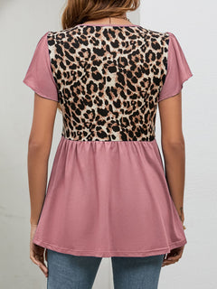 Back view of Leopard Round Neck Flutter Sleeve Babydoll Blouse showcasing chic leopard pattern and flutter sleeves.