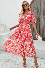 Smocked printed V-neck short sleeve dress in vibrant floral design, perfect for summer occasions.