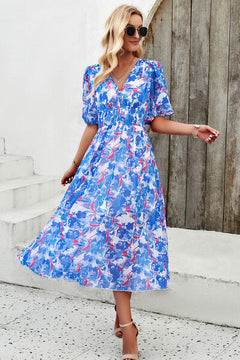 Smocked printed V-neck short sleeve dress in vibrant blue floral pattern, perfect for summer outings.