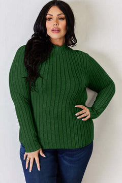 Model wearing a green ribbed mock neck long sleeve t-shirt, showcasing its stylish fit and design.