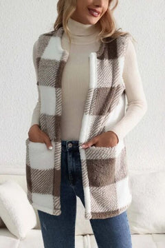 Woman wearing a Sherpa plaid open front vest coat over a turtleneck sweater, showcasing a cozy style.