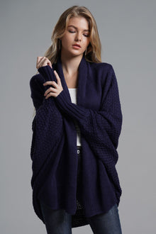 Model wearing a navy blue Double Take Dolman Sleeve Open Front Ribbed Trim Longline Cardigan in a studio setting.