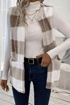 Sherpa plaid open front vest coat worn over a turtleneck with jeans, featuring soft fabric and a casual look.