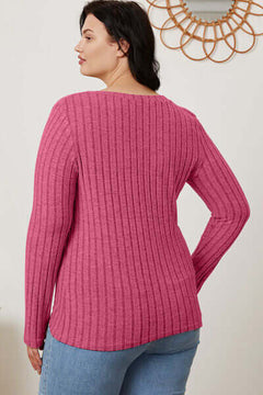 Model wearing a plus-size pink ribbed long sleeve T-shirt, showcasing a back view with a stylish, comfortable fit.
