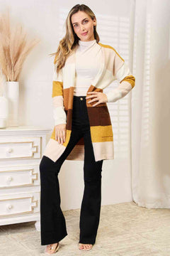 Color block dropped shoulder cardigan styled with black pants, offering a trendy and cozy look for any occasion.