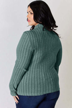 Plus-size model wearing a green ribbed mock neck long sleeve t-shirt, showcasing the back design.