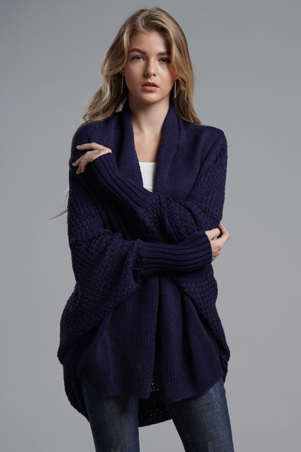 Model wearing a navy double take dolman sleeve open front longline cardigan with ribbed trim.