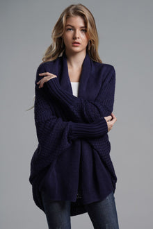 Model wearing a navy double take dolman sleeve open front longline cardigan with ribbed trim.