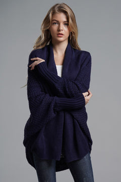 Model wearing a navy double take dolman sleeve open front longline cardigan with ribbed trim.