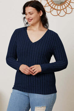 Basic Bae Full Size Ribbed V-Neck Long Sleeve T-Shirt in navy, styled with jeans and smiling model.