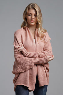 Model wearing a pink double take dolman sleeve cardigan with ribbed trim and open front styling.